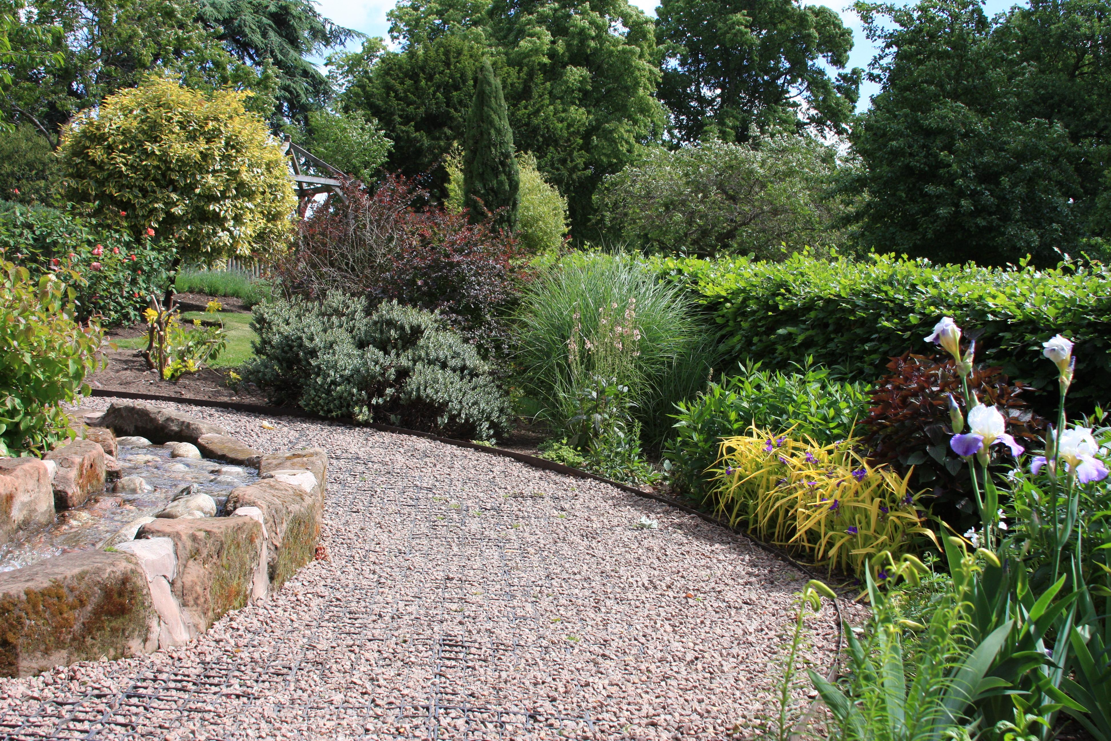 gravel path through planted flower beds