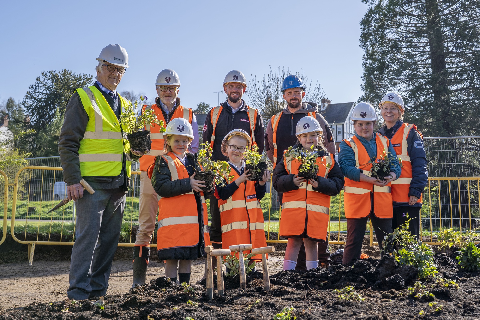 A group of people wearing high vis jackets and hard hats